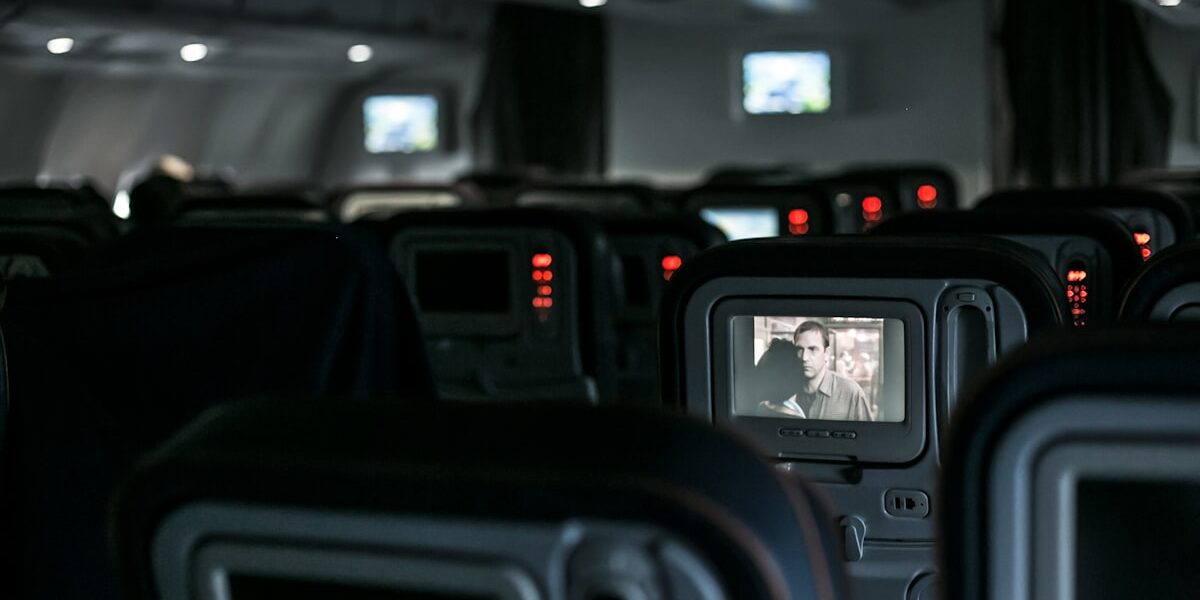 Airplane seat-back screen showing in-flight entertainment