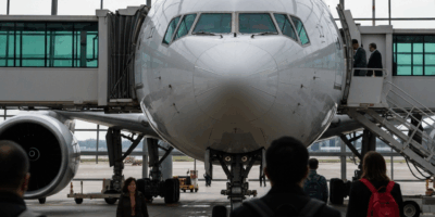 boeing 777 aircraft at airport gate with passengers boarding 20260331 090424